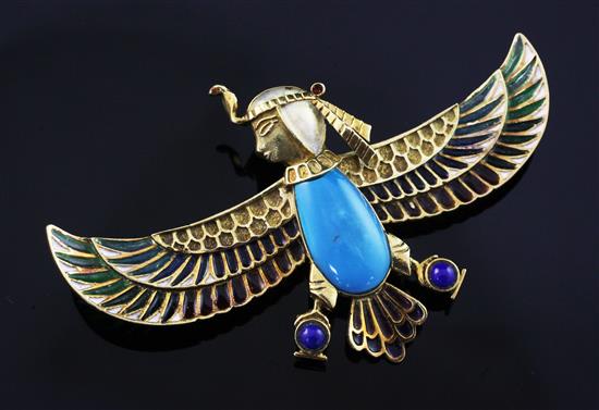 An Egyptian revival gold, plique a jour, turquoise and lapis lazuli winged falcon brooch with the head of a sphinx, 3in.